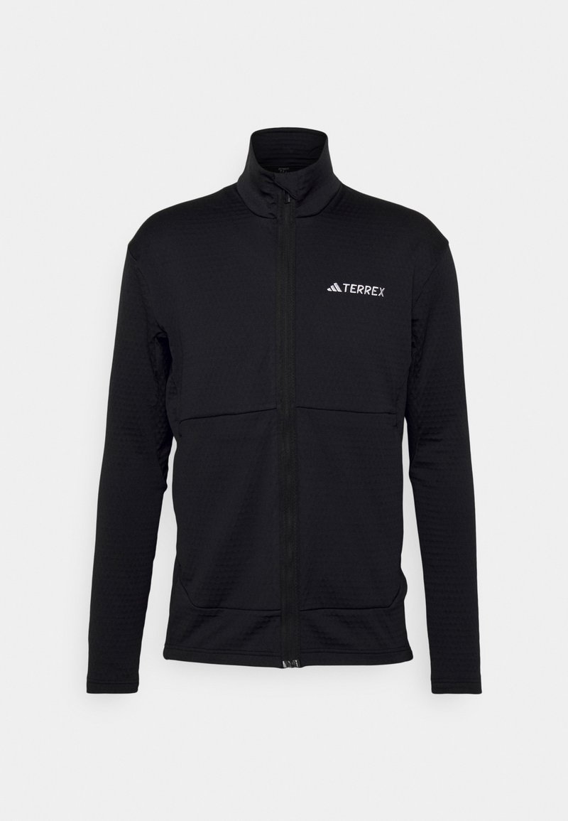 Zwarte Terrex ritsjack met lange mouwen, gestructureerde stof, hoge kraag en een ritssluiting aan de voorkant, met een wit logo op de borst.