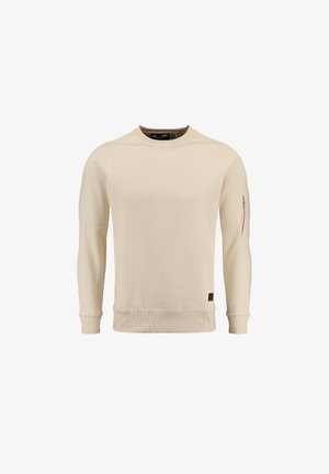 Sweat-shirt beige clair avec des poignets et un ourlet côtelés, comportant une poche à fermeture éclair sur la manche et un petit patch logo marron sur le côté.