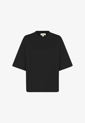 Black oversized t-shirt in soft fabric, featuring a round neck and short wide sleeves. Simple design with no patterns or accents.