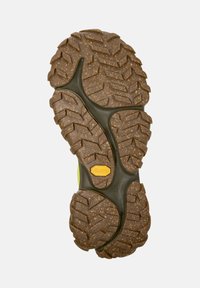 Suela texturizada de una bota de senderismo, con el logo de Vibram, diseñada para proporcionar tracción en varios tipos de terrenos. Los colores incluyen tonos de marrón y verde.