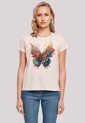 Light pink short-sleeve t-shirt featuring a multicolored butterfly design with floral accents, casual fit, and round neckline.