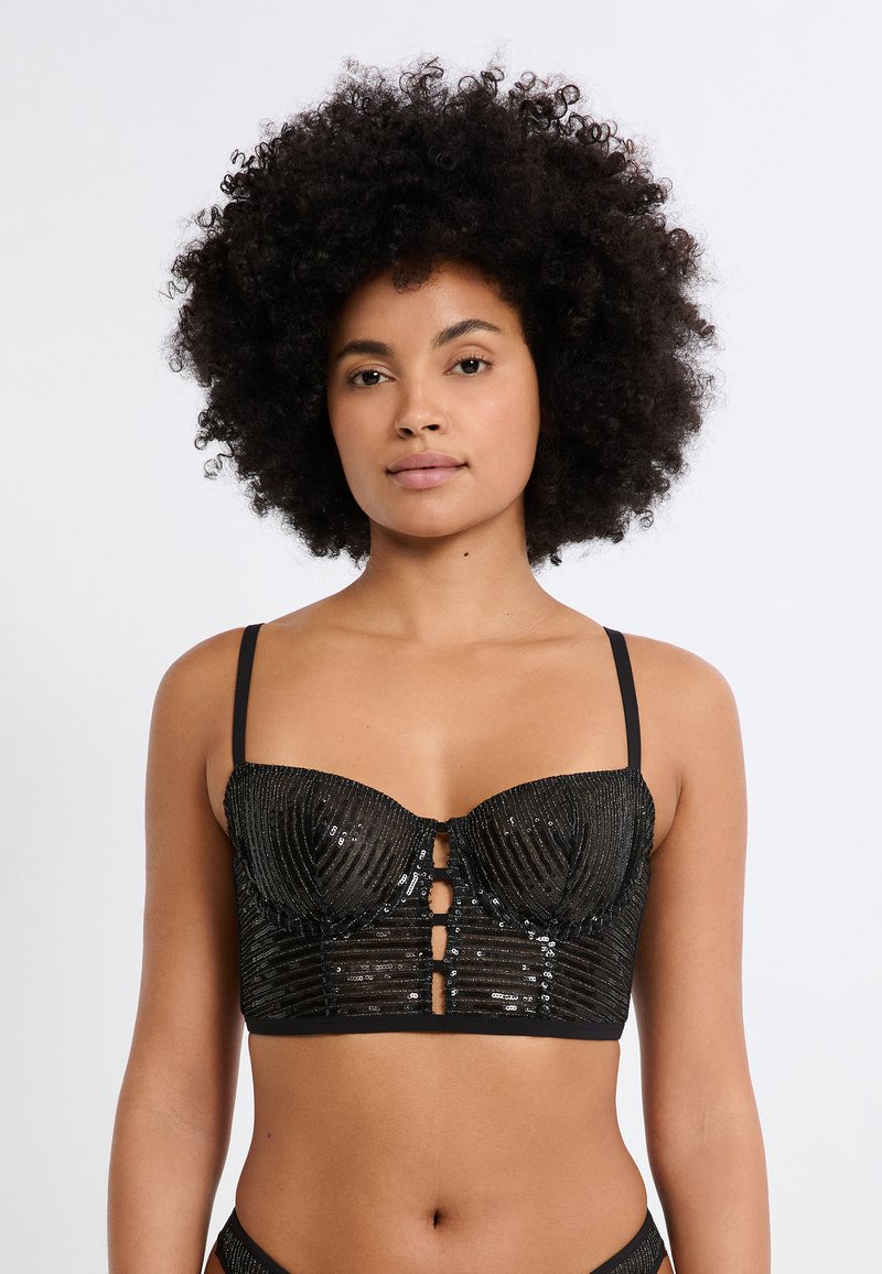 Schwarzes Bralette mit paillettenbesetzter Textur, strukturierten Cups und vertikalen Linien. Verfügt über verstellbare Träger und eine Vorderseite mit drei Knöpfen zum Verschließen.