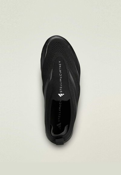 Black athletic shoe with a knitted mesh upper, sleek design, logo detail at the heel, and a smooth rubber sole.