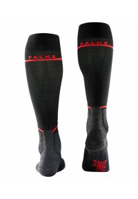Calcetines hasta la rodilla en negro y gris con una textura acanalada. Acentos rojos y el logo "FALKE" en la parte superior. Áreas de talón y puntera reforzadas.