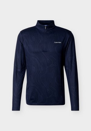 Pull-over bleu marine à manches longues avec demi-fermeture éclair et motif topographique abstrait discret, logo blanc Calvin Klein sur la poitrine.