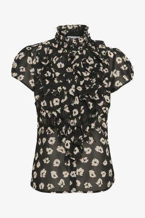 Svart blus med korta puffärmar, med en volangdesign fram och ett krämfärgat blommönster. Tillverkad av lätt, genomskinligt tyg.