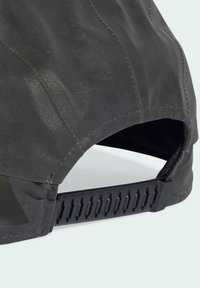 Black cap with a smooth, shiny fabric, curved brim, and a patterned adjustable strap at the back for a secure fit.