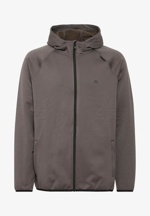 Kapucnis dzseki tompa barna-szürke színben, puha anyagból készült. Elöl cipzáros, két oldalsó zsebe és egy diszkrét logója van.