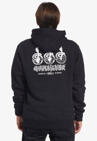 Black hooded sweatshirt featuring a graphic of three globes with music notes, textured lettering, and ribbed cuffs and hem.