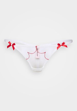 Hvitt blondetruse med rød broderi og sløyfe detaljer. Har et merke med merkevarenavnet. Glatt stoff med bølgete kanter.