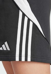 Pantaloni sportivi neri realizzati in misto cotone, con tre strisce bianche lungo il lato e un piccolo logo sull'orlo inferiore.