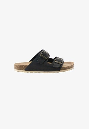 Sandalia negra de punta abierta con dos tiras ajustables con hebilla y plantilla de corcho sobre una suela beige con textura, vista lateral.