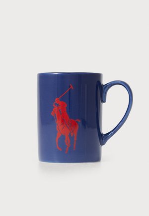 Blue ceramic mug with a red polo player graphic, curved handle, smooth texture, and glossy finish.