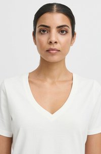 White V-neck T-shirt made of soft fabric, featuring short sleeves and a relaxed fit. Simple design with no patterns or embellishments.