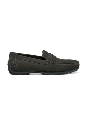 Mocasines de ante gris oscuro con suela plana de goma, acentos cosidos y una pequeña sección elevada en la parte superior para un ajuste seguro.