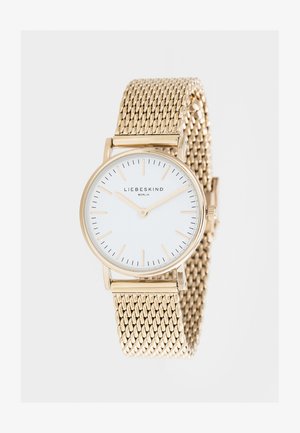 Guldfarvet mesh-ur med en rund hvid urskive, minimalistiske guldtimerindikatorer og et centralt logo. Elegant og moderne design.