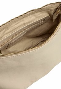 Beige Ledertasche mit goldfarbenem Reißverschluss, mit einer glatten Textur und einem geräumigen Innenraum. Beinhaltet eine kleine Reißverschlusstasche im Inneren.