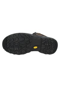 Suela de goma negra con surcos profundos y angulares. Cuenta con un logo amarillo de Vibram, diseño resistente y texturizado para mayor tracción.