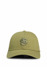 Olive green cap with a textured fabric. Features a stitched emblem, curved brim, and six panel design with ventilation eyelets.