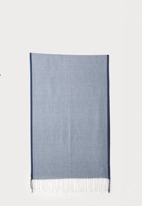 Blue woven blanket with a textured surface, featuring white fringe along the bottom edge and dark blue border on the sides.
