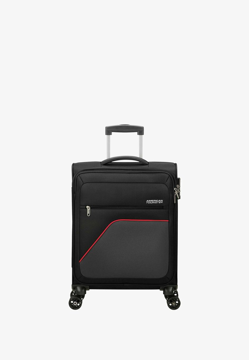 Valise noire en tissu avec une surface texturée, dotée d'une ligne d'accent rouge, d'une poignée rétractable et de quatre roues pivotantes.