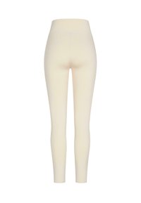 Leggings od mješavine pamuka u blagoj krem boji, s visokim strukom i rastezljivom, glatkom teksturom bez vidljivih šavova ili uzoraka.