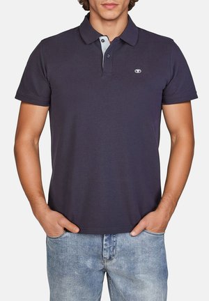 Navy polo shirt with a classic collar, three-button placket, and contrasting light blue detailing. Made from breathable fabric.