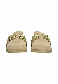 Zapatos sin cordones de ante beige con correas de tela en verde, amarillo y blanco con un patrón, que presentan grandes hebillas plateadas, mostrados desde una vista frontal.