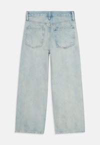 Light blue denim jeans with a straight-leg design, featuring two back pockets and fading across the fabric. Classic five-pocket style.