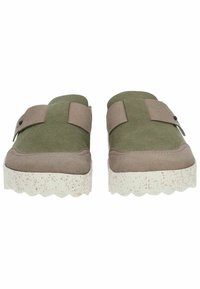Green and beige slip-on shoes with a textured upper, featuring a wide strap and a scalloped white sole with speckled accents.