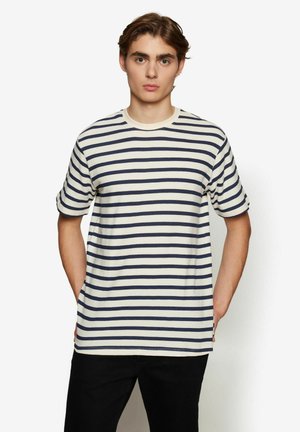 Striped t-shirt in cream and navy blue, short sleeves, crew neckline, cotton fabric, featuring even horizontal stripes and a relaxed fit.