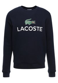 Felpa blu navy in cotone, con scollatura a girocollo, maniche lunghe e un logo di coccodrillo verde con la scritta "LACOSTE" stampata in bianco.