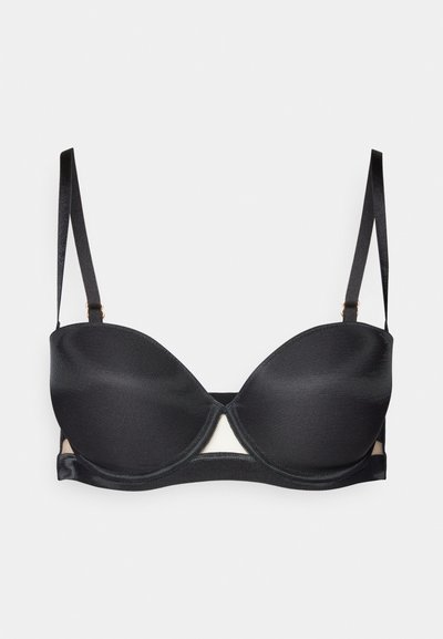 Reggiseno nero in tessuto morbido, con supporto a ferretto e spalline regolabili. Presenta un ritaglio triangolare sul davanti e pannelli laterali trasparenti.