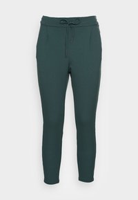 Mörkgröna, avsmalnande joggers med dragsko i midjan, sidofickor och en mjuk, lätt tygtextur.