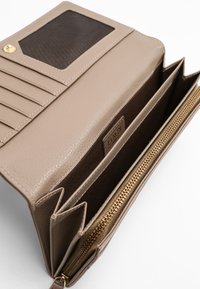 Beige leather wallet with textured finish, multiple card slots, a clear ID window, and a gold zippered compartment. Interior is brown fabric.
