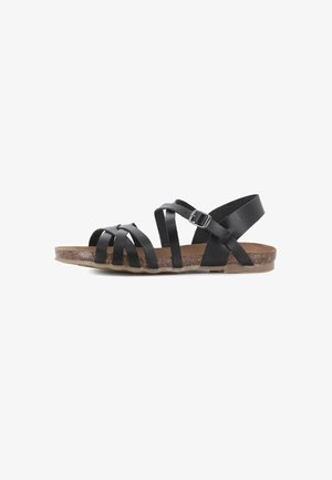Sandalia negra de cuero con múltiples correas, hebilla ajustable, suela con textura de corcho y suela exterior plana de goma, vista lateral.