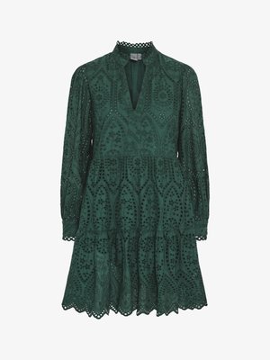 Green lace dress with a v-neck, long sleeves, and a tiered skirt. Features intricate cutout patterns and scalloped edges along the hem.