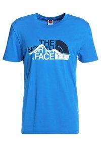 Blå bomulls-T-shirt med "THE NORTH FACE"-logotyp i svart och vitt, rund halsringning, korta ärmar och en mjuk textur.