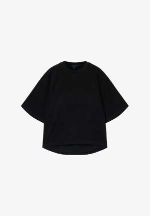Zwarte oversized T-shirt met korte mouwen, ronde halslijn en een gebogen zoom. Gemaakt van gestructureerde stof, ontworpen voor een ontspannen pasvorm.
