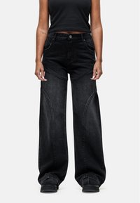 SUTURE - Flared Jeans - black