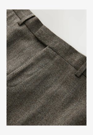 Brown herringbone fabric, featuring a textured pattern with fine lines. The waistband has a flat front design and belt loops.