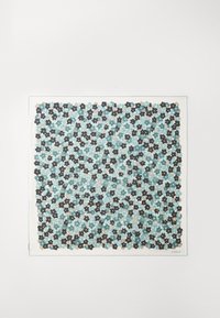 Colorful fabric with a repeat pattern of black and dark blue flowers on a soft turquoise background; edged with a white border and brand label.
