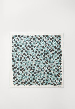 Colorful fabric with a repeat pattern of black and dark blue flowers on a soft turquoise background; edged with a white border and brand label.
