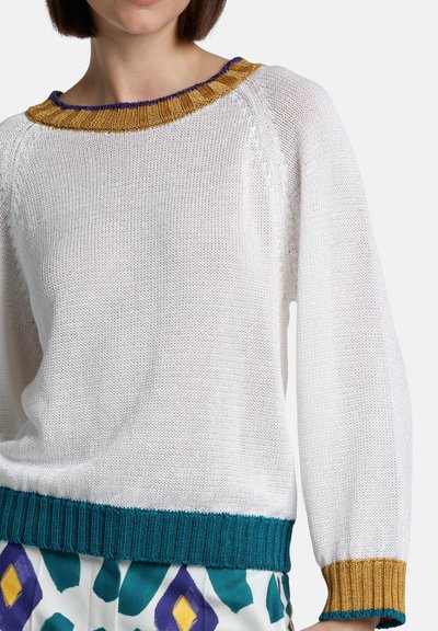 White knitted sweater with a round neckline, featuring a gold and purple ribbed collar, and teal ribbed cuffs at the hem.