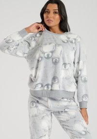 Pullover in pile grigio con un motivo di pinguini, maniche lunghe e collo a coste. Texture morbida con una vestibilità comoda e pantaloni coordinati.