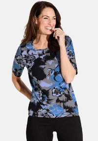 Kurzarmliges Blumenoberteil in einer Kombination aus Blau und Schwarz, mit rundem Ausschnitt und glatter Stoffstruktur.