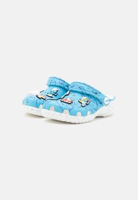 Blue foam clogs with raised patterns, white sole, and colorful character decorations on the upper surface. Smooth texture, round toe design.