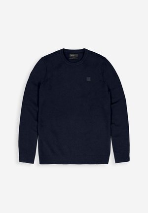 Marineblauwe sweatshirt met ronde hals, gemaakt van zachte stof, met lange mouwen en geribbelde manchetten, en een subtiele logopatch op de borst.