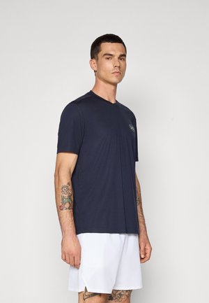 Navy blue athletic t-shirt in lightweight fabric with short sleeves and a v-neck design. Features a small logo on the chest.