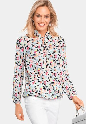 Lichtblauwe blouse met een bloemen- en luipaardprint in roze, oranje en zwarte tinten, met lange mouwen en een keyhole halsontwerp.